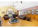 Spacious living room with hardwood floors, a fireplace, and large windows at 1426 Sc-45, McClellanville, SC 29458