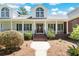 Two-story home with brick and white siding, and a wrap-around porch at 1426 Sc-45, McClellanville, SC 29458