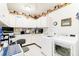 Convenient laundry room with white cabinets and a workspace at 1426 Sc-45, McClellanville, SC 29458