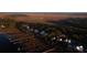 Aerial view of waterfront property with homes and private docks at sunset at 1473 Jeremy Cay Ct, Awendaw, SC 29429