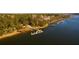 Aerial view of waterfront property with private docks and lush landscaping at 1473 Jeremy Cay Ct, Awendaw, SC 29429