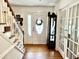 Bright entryway with hardwood floors, staircase, and glass-paned doors at 138 Waddell Ln, Ridgeville, SC 29472