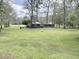 Large backyard with open space, detached garage, and mature trees at 138 Waddell Ln, Ridgeville, SC 29472