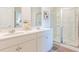 Modern bathroom with double vanity, large mirror and glass shower at 159 Morning View Way, Moncks Corner, SC 29461