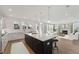 Open concept kitchen with island, living area view, and hardwood floors at 1714 Cultivation Ln # 537, Mount Pleasant, SC 29466