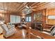 Cozy living room with wood walls, fireplace, and comfortable seating at 712 W Ashley Ave, Folly Beach, SC 29439