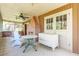 Rustic screened porch with brick fireplace and antique dresser at 712 W Ashley Ave, Folly Beach, SC 29439