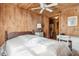 Cozy bedroom with wood walls, a double bed, and a small desk at 712 W Ashley Ave, Folly Beach, SC 29439