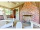 Screened porch with brick fireplace and wooden chairs at 712 W Ashley Ave, Folly Beach, SC 29439