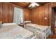 Two twin beds in a small bedroom with wood walls at 712 W Ashley Ave, Folly Beach, SC 29439