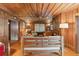Cozy living room with wooden walls, ceiling, and floors at 712 W Ashley Ave, Folly Beach, SC 29439