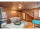 Cozy living room with wood paneling, wood floors, and vintage furniture at 712 W Ashley Ave, Folly Beach, SC 29439
