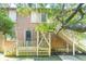 Exterior view of a house with wooden stairs and a screened porch at 712 W Ashley Ave, Folly Beach, SC 29439