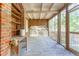 Screened porch with brick wall and wooden floors at 712 W Ashley Ave, Folly Beach, SC 29439