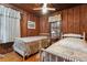 Two twin beds in a bedroom with wood walls and windows at 712 W Ashley Ave, Folly Beach, SC 29439