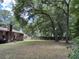 Large backyard surrounded by trees and a wooden fence at 1056 Yorktown Dr, Charleston, SC 29412