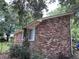Brick home showcasing a side view with large windows and landscaping at 1056 Yorktown Dr, Charleston, SC 29412