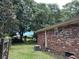 Brick home exterior with AC unit and mature trees at 1056 Yorktown Dr, Charleston, SC 29412