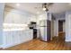 Modern kitchen with white cabinets, stainless steel appliances, and mosaic backsplash at 118 E Ashley And 110 E Cooper Ave Ave, Folly Beach, SC 29439