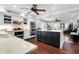 Open concept kitchen with dark island, white cabinets, and stainless steel appliances at 118 E Ashley And 110 E Cooper Ave Ave, Folly Beach, SC 29439