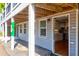 Inviting exterior with a covered porch and visible kitchen at 118 E Ashley And 110 E Cooper Ave Ave, Folly Beach, SC 29439