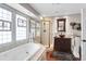 Elegant bathroom with a soaking tub, walk-in shower, and stained glass windows at 118 E Ashley And 110 E Cooper Ave Ave, Folly Beach, SC 29439
