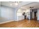 Open concept kitchen and living area with white cabinets and hardwood floors at 118 E Ashley And 110 E Cooper Ave Ave, Folly Beach, SC 29439