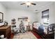 Bright bedroom with hardwood floors, antique bed, and a decorative Christmas tree at 118 E Ashley And 110 E Cooper Ave Ave, Folly Beach, SC 29439