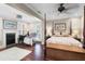 Large main bedroom with a fireplace, hardwood floors, and a comfy sitting area at 118 E Ashley And 110 E Cooper Ave Ave, Folly Beach, SC 29439