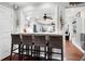 Kitchen breakfast bar with four wicker barstools, open to the living area at 118 E Ashley And 110 E Cooper Ave Ave, Folly Beach, SC 29439