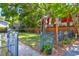 Landscaped front yard with gate and mature trees at 118 E Ashley And 110 E Cooper Ave Ave, Folly Beach, SC 29439