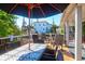 Deck with patio furniture and umbrella, offering shade at 118 E Ashley And 110 E Cooper Ave Ave, Folly Beach, SC 29439