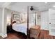 Main bedroom with a four-poster bed, built-in closet, and hardwood floors at 118 E Ashley And 110 E Cooper Ave Ave, Folly Beach, SC 29439