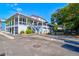 Two-story home with a wrap-around porch and a fenced backyard at 118 E Ashley And 110 E Cooper Ave Ave, Folly Beach, SC 29439