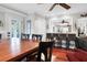 Bright dining area with wooden table and access to the kitchen and backyard at 118 E Ashley And 110 E Cooper Ave Ave, Folly Beach, SC 29439