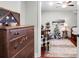 Charming bedroom with hardwood floors, antique dresser, and cozy sitting area at 118 E Ashley And 110 E Cooper Ave Ave, Folly Beach, SC 29439