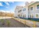 Two-story building with gray siding, balconies, and a wooden fence at 420 Carolina Cherry Ct # 201, Charleston, SC 29414