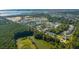 Aerial view of a coastal community featuring houses around a central pond at 1635 Cultivation Lane St # 448, Mount Pleasant, SC 29466