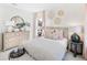 Cozy bedroom with striped bedding, light wood dresser, and round mirror at 1635 Cultivation Lane St # 448, Mount Pleasant, SC 29466