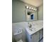 Updated bathroom features a white vanity, marble countertop, and tiled floors at 401 Constance St, Walterboro, SC 29488