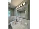 Updated bathroom features a white vanity, marble countertop, and tiled floors at 401 Constance St, Walterboro, SC 29488