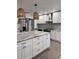 Modern kitchen with white cabinets, granite countertops, and stainless steel appliances at 401 Constance St, Walterboro, SC 29488