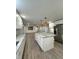 Bright kitchen with white cabinets, granite counters, and an open floor plan at 401 Constance St, Walterboro, SC 29488