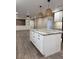 Renovated kitchen with white cabinets, granite countertops, and large island at 401 Constance St, Walterboro, SC 29488