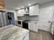 Modern kitchen with white cabinets, granite countertops, and stainless steel appliances at 401 Constance St, Walterboro, SC 29488