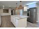 Remodeled kitchen with island, stainless steel appliances, and white shaker cabinets at 401 Constance St, Walterboro, SC 29488