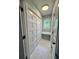 Bright laundry room with built-in storage and marble-look tile floor at 401 Constance St, Walterboro, SC 29488