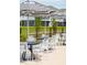 Relaxing poolside seating with black and white striped umbrellas at 1698 Cultivation Ln # 541, Mount Pleasant, SC 29466