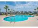 Relaxing pool area with lounge chairs and palm trees at 1698 Cultivation Ln # 541, Mount Pleasant, SC 29466