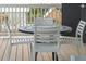 Round metal table with four white chairs on a wooden deck at 1698 Cultivation Ln # 541, Mount Pleasant, SC 29466